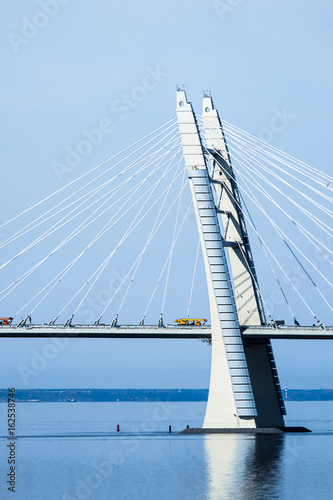 Fototapeta Naklejka Na Ścianę i Meble -  Cable-Stayed Bridge with auto cranes at sunny spring day.