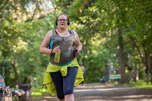 Overweight woman running. Weight loss concept.