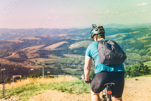 young man riding on MTB in mountains