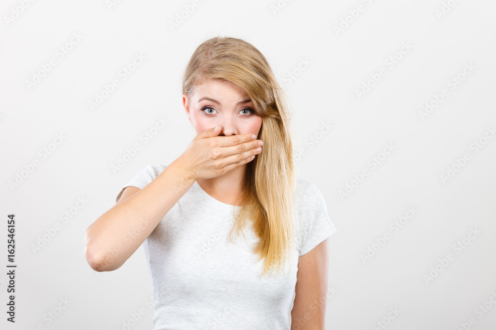 Ashamed woman having hand on mouth Ashamed woman having hand on mouth