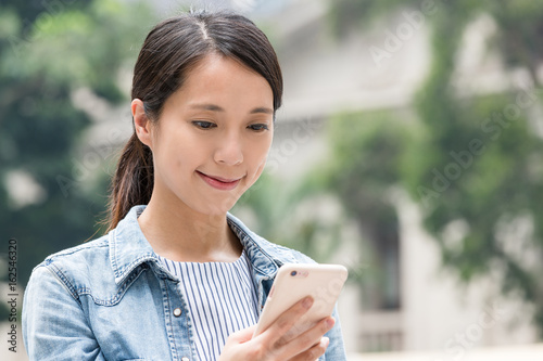 Photography Young woman watching on mobile phone