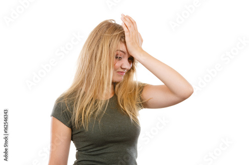 Ashamed embarrassed blonde woman with hand on face © Voyagerix