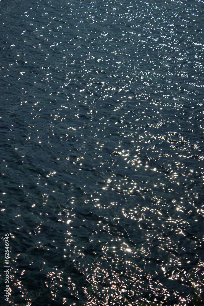 Dark blue water, a sea under sun rays background Dark blue water, a sea under sun rays background