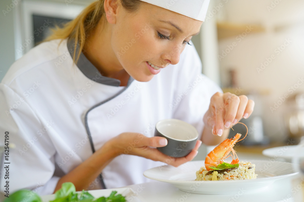 Chef preparing dish in professional kitchen Chef preparing dish in professional kitchen