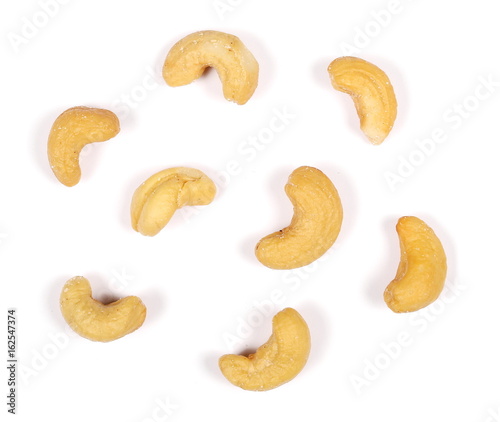 Unshelled roasted and salted cashew nuts isolated on white background, top view
