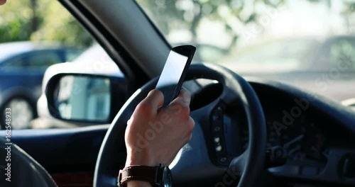 Wallpaper Mural Confident on the road. Young man sitting in his newly bought car with smartphone copyspace insurance safety driving successful wealthy lifestyle consumerism purchase buy concept Torontodigital.ca