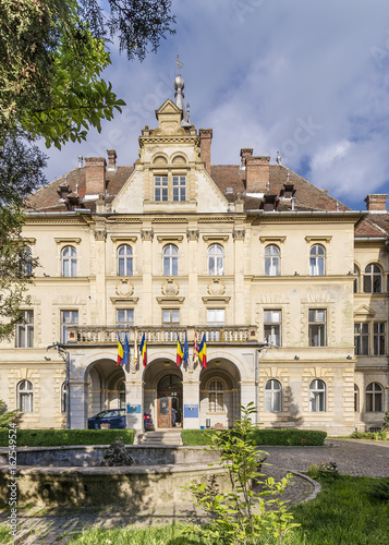 The facade of Primaria Municipiului, Sighisoara City Hall, Romania, on a sunny day photo