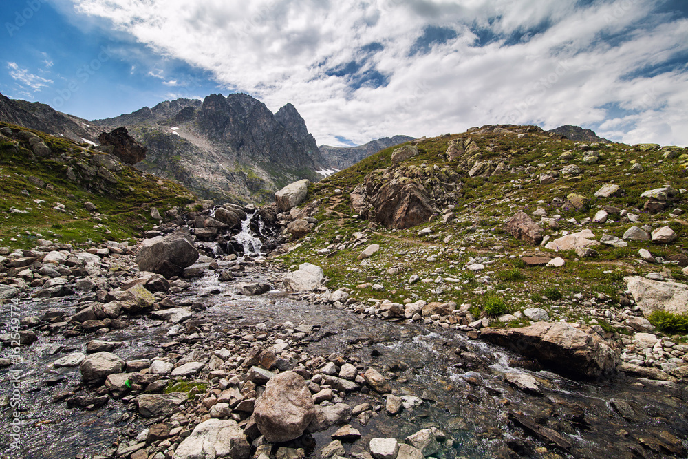 Obraz premium mountain river at the foot of the cliff