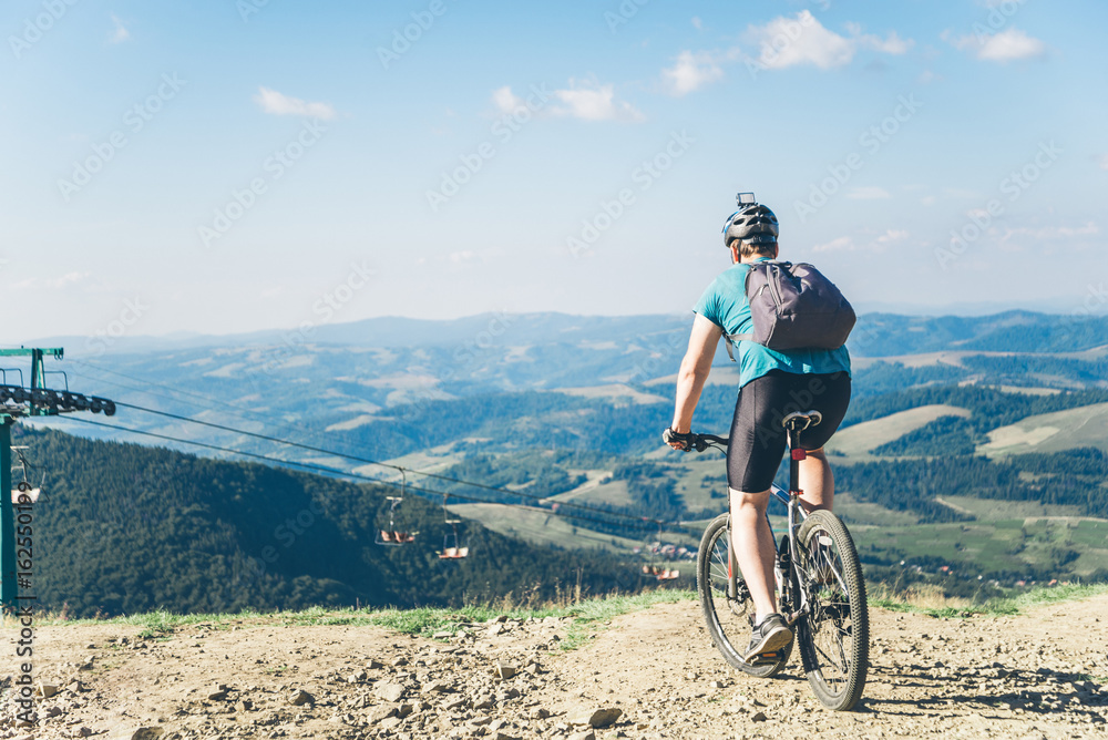 young man riding on MTB in mountains