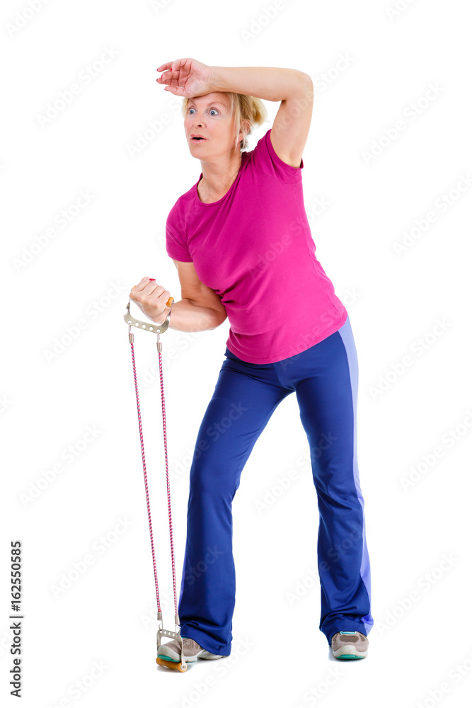 Emotions on face. Old senior blonde woman dressed in t-shirt color Marsala doing fitness exercises with expander a resistance band, isolated on white background, human emotions Emotions on face. Old senior blonde woman dressed in t-shirt color Marsala doing fitness exercises with expander a resistance band, isolated on white background, human emotions