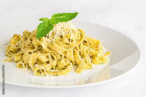fettuccine pesto decorated with basil leafs