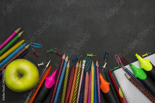 School supplies on blackboard background