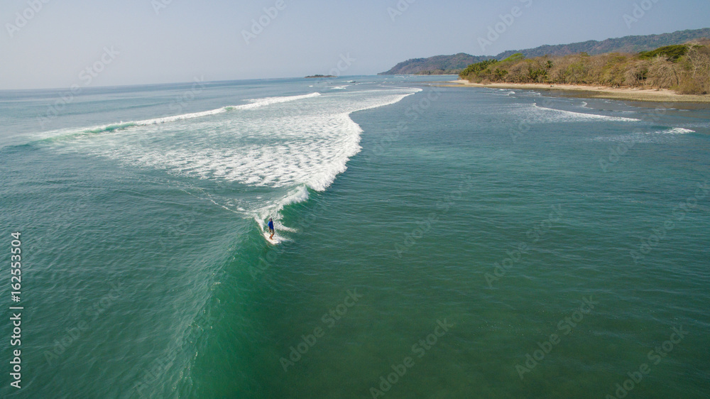 Aerial view of a surfer on a wave in Santa Teresa, Costa Rica