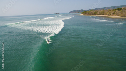 Obraz na płótnie Aerial view of a surfer on a wave in Santa Teresa, Costa Rica w salonie