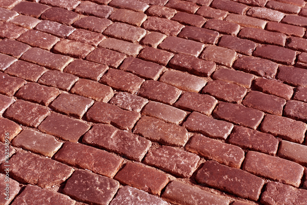 Old stone pavement pattern in red tone. Old stone pavement pattern in red tone.