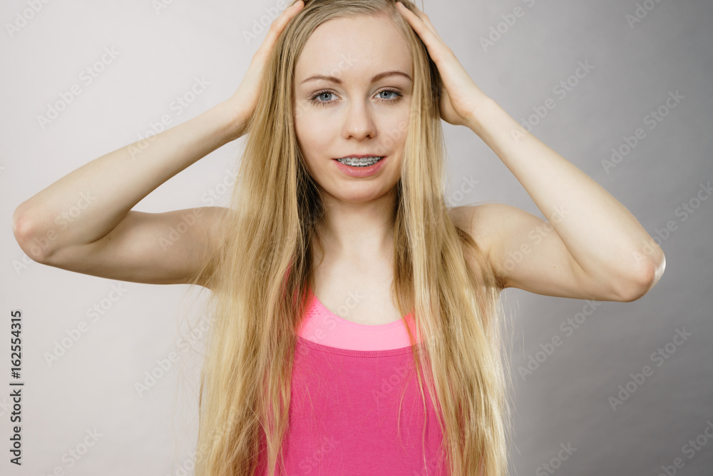 Young woman touching her long hair Young woman touching her long hair