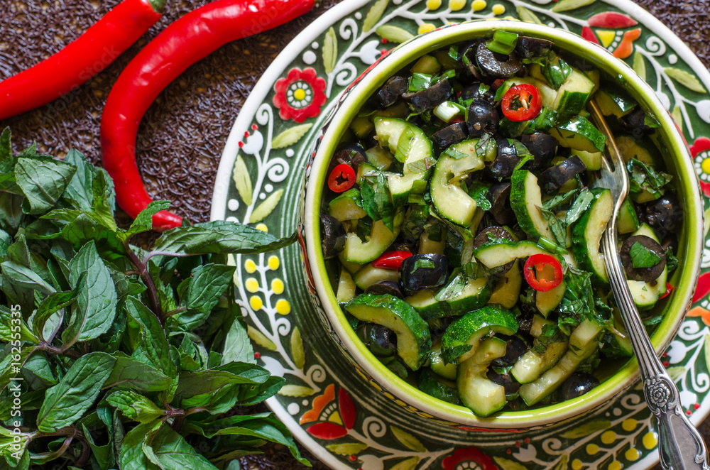 Salad with cucumbers olives chili and mint