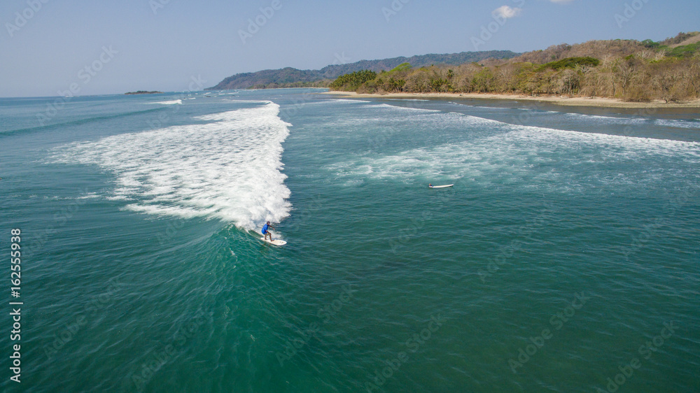 Aerial view of a surfer on a wave in Santa Teresa, Costa Rica