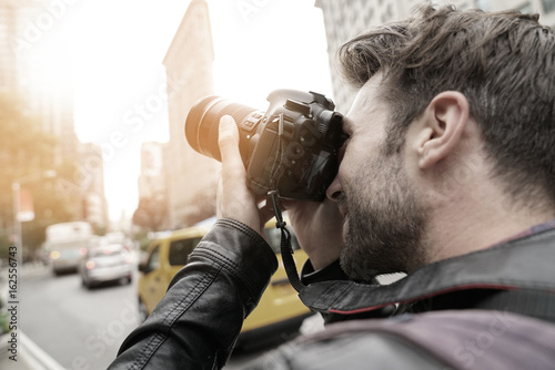 Tourist in New york city taking pictures with photo camera