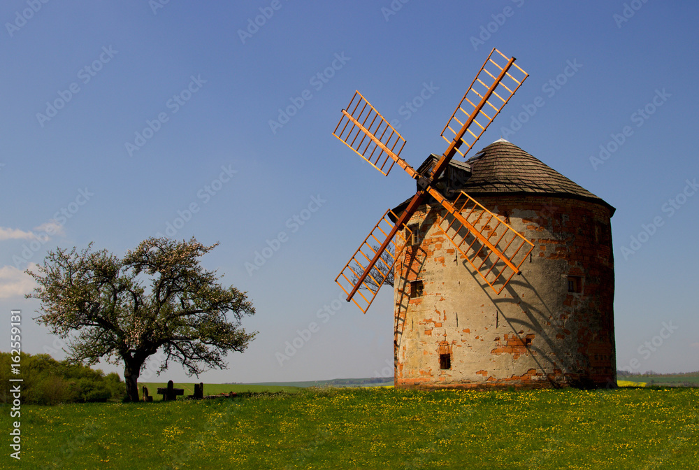 Fototapeta premium Old windmill with sunset and blue sky