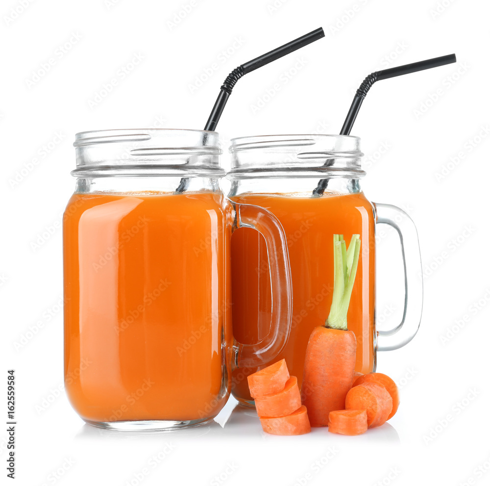 Mason jars of delicious carrot juice with slices, on white background Mason jars of delicious carrot juice with slices, on white background