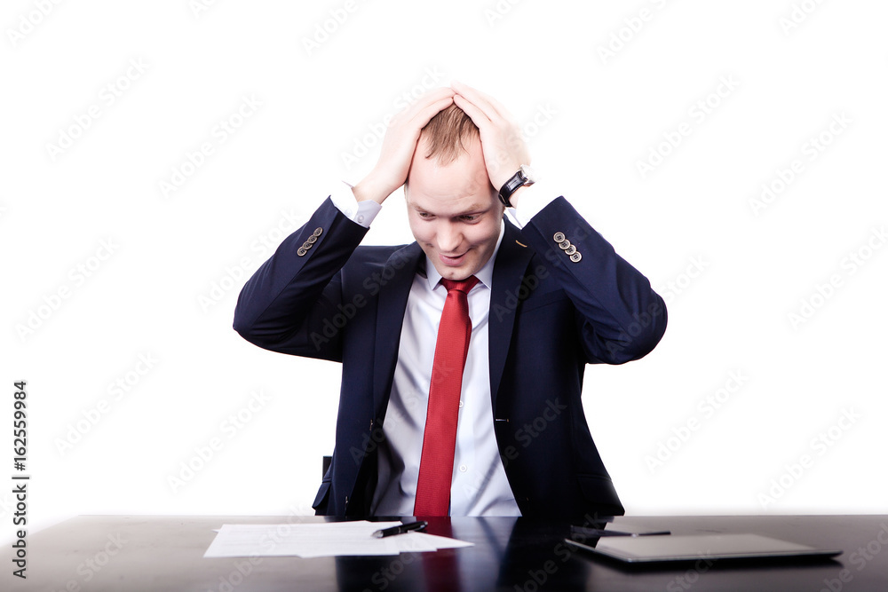 A young man is having an expression of surprise on his face when checking the numbers on a paper, on white background A young man is having an expression of surprise on his face when checking the numbers on a paper, on white background