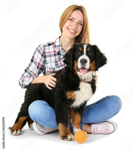 Young woman with cute funny dog on white background
