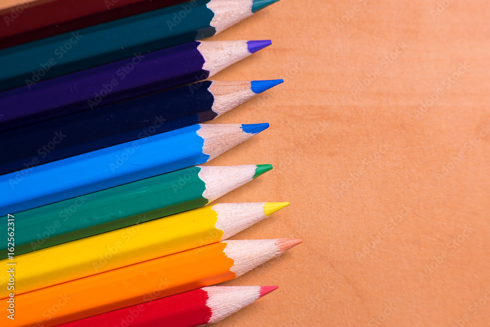 Color pencils on wood background close up Color pencils on wood background close up