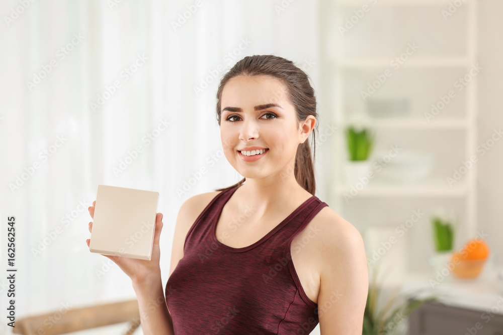 Beautiful young woman with biologically active supplement at home. Diet concept Beautiful young woman with biologically active supplement at home. Diet concept
