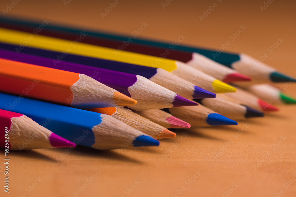Color pencils on wood background close up Color pencils on wood background close up