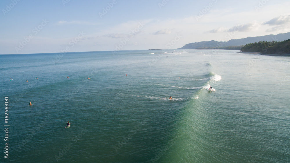Aerial view of a surfer on a wave in Jaco, Costa Rica
