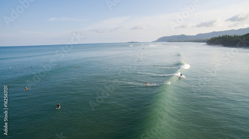 Obraz na płótnie Aerial view of a surfer on a wave in Jaco, Costa Rica w salonie