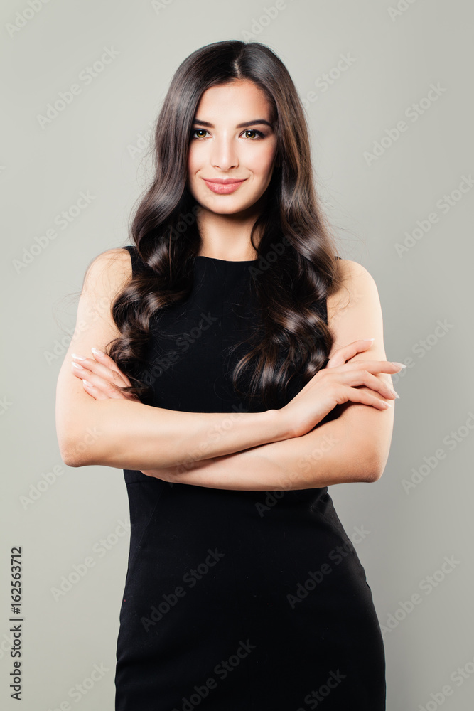 Perfect Brunette Woman with Curly Hair and Makeup. Beautiful Fashion Model in Black Dress Perfect Brunette Woman with Curly Hair and Makeup. Beautiful Fashion Model in Black Dress