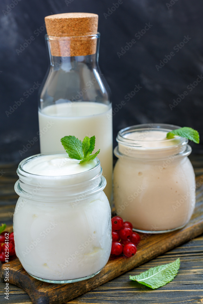 Milk, yogurt and sour baked milk in glass jars. Milk, yogurt and sour baked milk in glass jars.