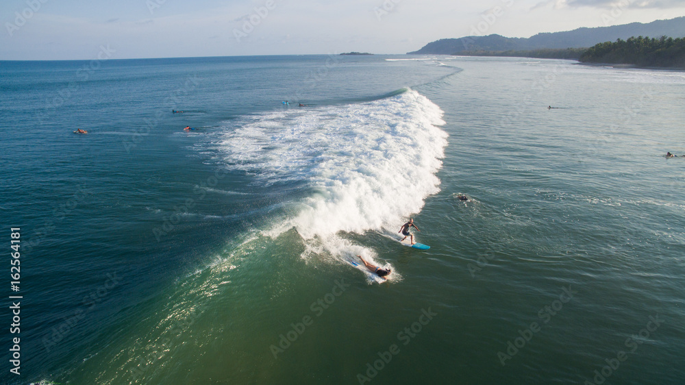 Aerial view of a surfer on a wave in Jaco, Costa Rica