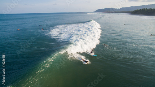 Obraz na płótnie Aerial view of a surfer on a wave in Jaco, Costa Rica w salonie
