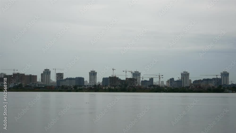 Panorama of the city near the lake. Shallow rain in the open air Panorama of the city near the lake. Shallow rain in the open air