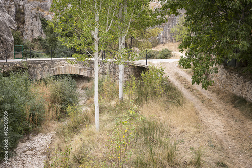 ancient bridge over a dry river at Huesa del Comun, Teruel, Spain photo