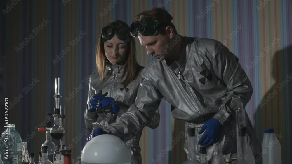 Chemical laboratory. Close-up of the flasks with the chemicals that stand on the table, boil and smoke in Slow motion
