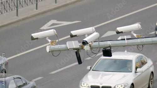 Closeup of four traffic security camera surveillance CCTV on the road in the big city photo