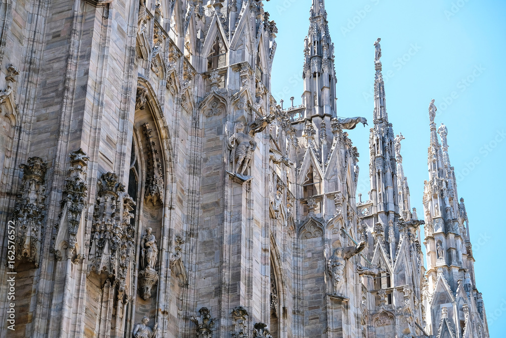 Milan, Italy - June, 19, 2017: Facade of Milan Cathedral - one of the famoust examples of the Italian gothic architecture
