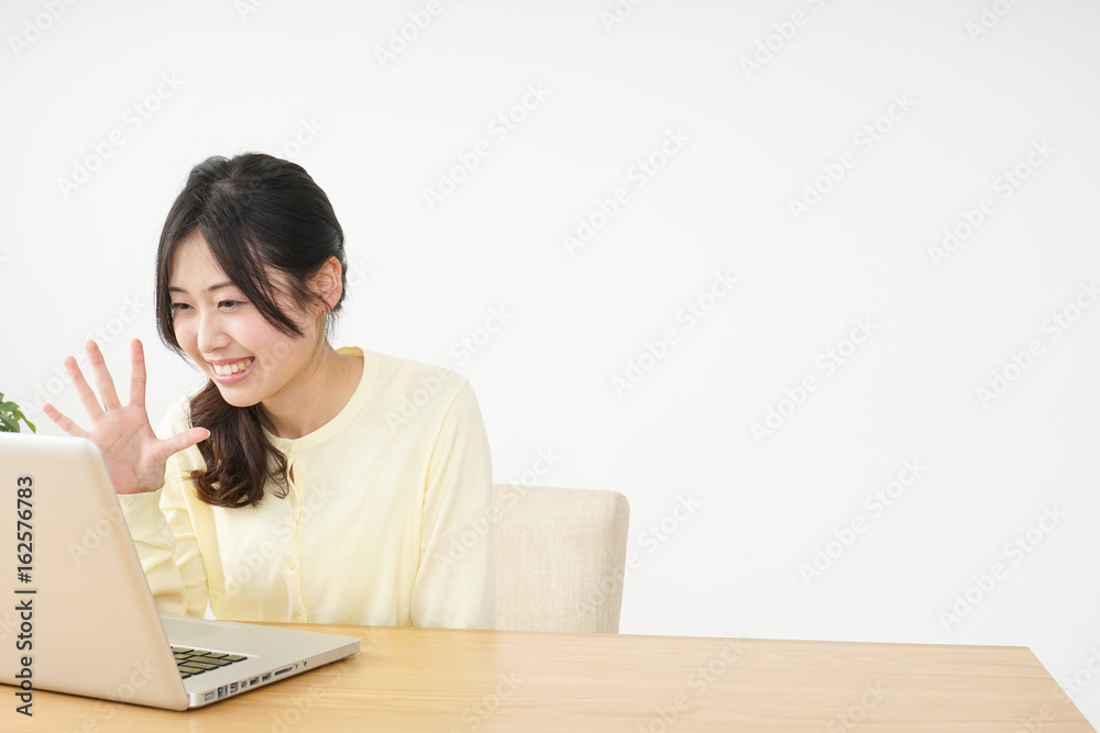 Young woman making a video-phone call Young woman making a video-phone call