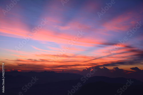 First rays of the rising sun. Misty mountains in the morning. Sunrise at the Adam's Peak (Sri Pada Mountain), Sri Lanka