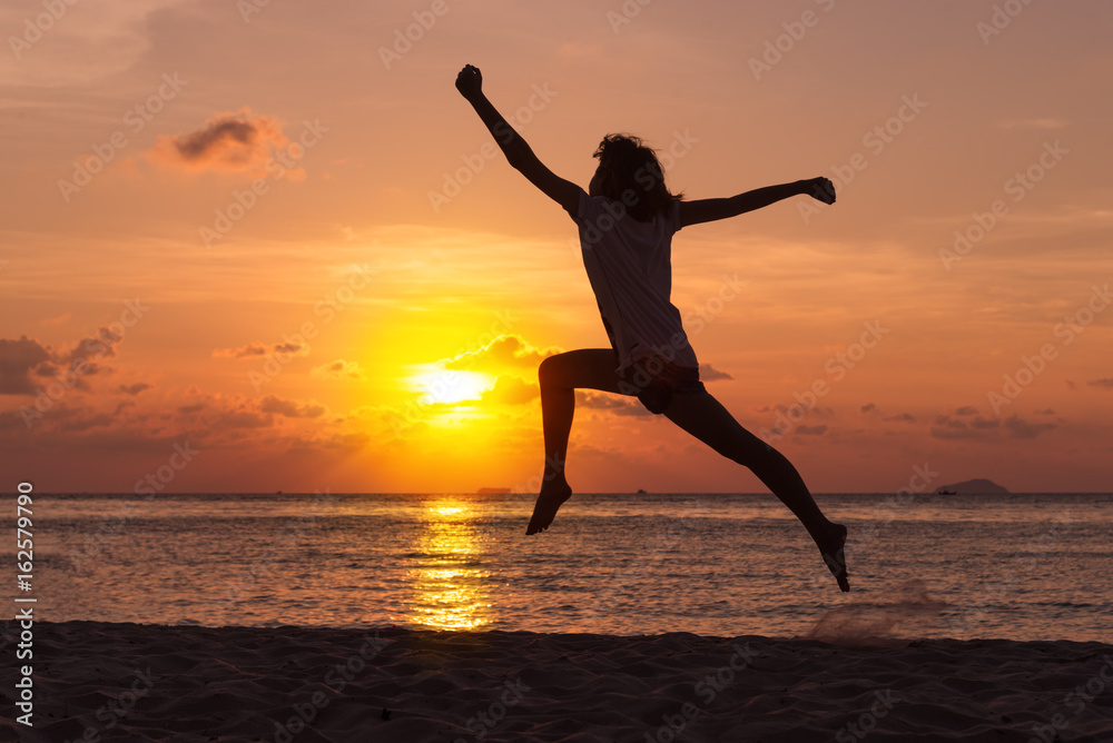 Freedom concept with young teenager happy and jump on beach