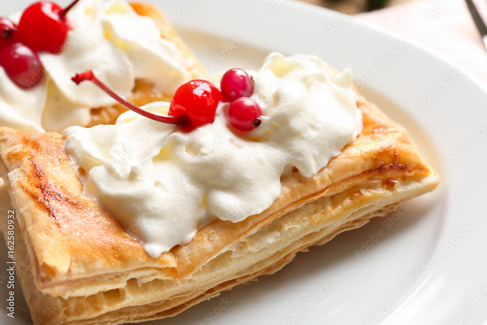 Tasty puff pastry dessert with berries and whipped cream on plate Tasty puff pastry dessert with berries and whipped cream on plate