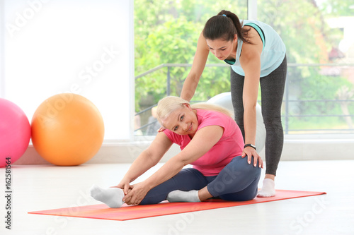 Instructor helping senior w...