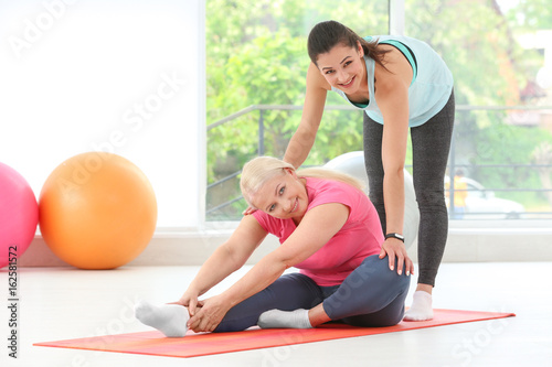 Instructor helping senior w...