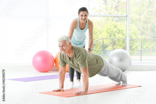 Instructor helping senior m...