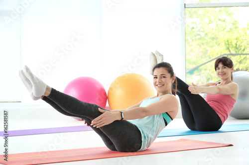 Women practicing yoga in mo...