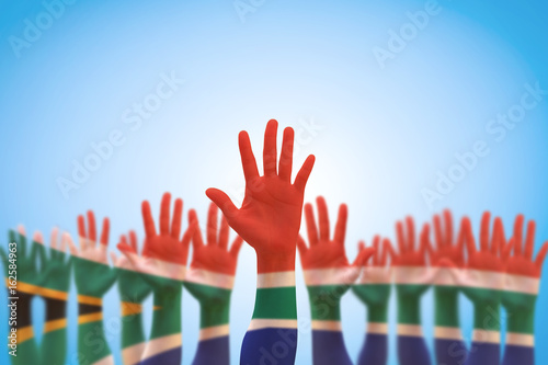 South Africa national flag on leader's palms isolated on blue sky for human rights, leadership, reconciliation concept photo